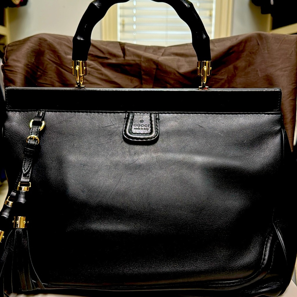 Slightly used black Gucci bag with snap closures